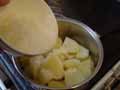 Adding grated Parmesan cheese Adding grated Parmesan cheese