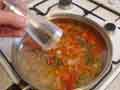 Adding ground black pepper