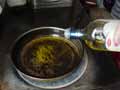 Adding olive oil to frying pan