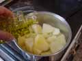 Adding olive oil to potatoes Adding olive oil to potatoes