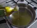 Adding olive oil to frying pan