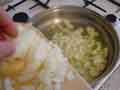 Adding onion to frying pan