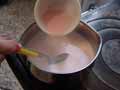 Adding strawberry blancmange mix to milk