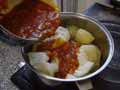 Adding tomato sauce to potatoes Adding tomato sauce to potatoes