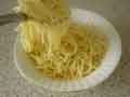 Adding spaghetti to bowl Adding spaghetti to bowl