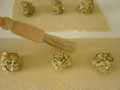 Brushing the egg white in between the tortelli mounds