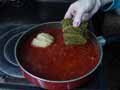 Place stuffed cabbage leaves in sauce Place stuffed cabbage leaves in sauce