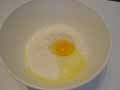 Adding egg to flour Adding egg to flour
