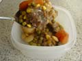 Placing stew in plastic containers ready for freezing