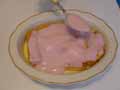 Spoon strawberry blancmange over second biscuit layer