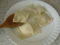 Spooning tortelli onto plate