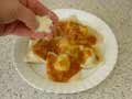Sprinkle grated Parmesan cheese over tortelli