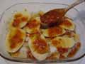 Tomato coating on second layer of potatoes